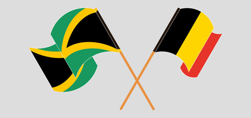 Crossed and waving flags of Jamaica and Belgium