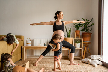 Pregnant woman practicing yoga at home