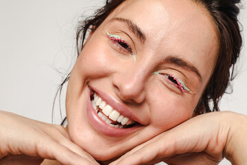 Young woman with green eyeliner and pink mascara
