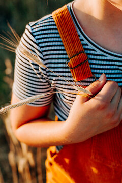 Yellow grain holding to chest.