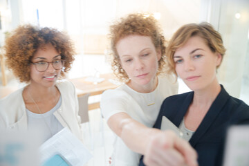 Three office workers talking at office