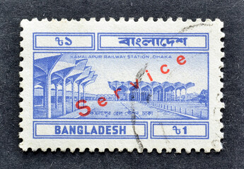Cancelled Postage stamp printed in Bangladesh shows Kamalapur railway Station, Dhaka, with red Service overprint, circa 1983.