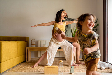 Couple practicing yoga together at home