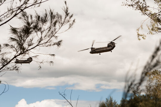 Silhouette of helicopters against clear sky