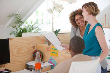 Office workers talking at desk