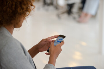 Businesswoman using smartphone in office