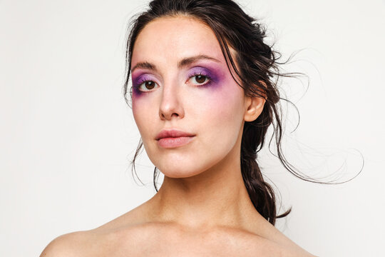 Beautiful woman with purple makeup on 