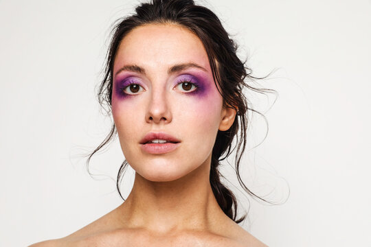 Beautiful woman with purple makeup on 