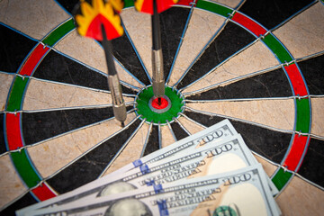 Playing darts for money (dollars).