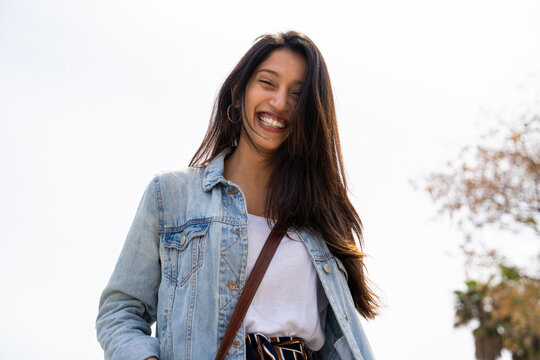 Portrait of happy young woman outdoors looking at camera