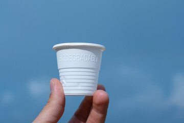 Man hand hold biodegradable eco friendly plastic glass,environment sustainability packaging