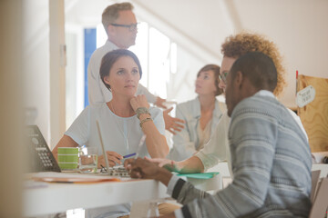 Office workers talking at desk