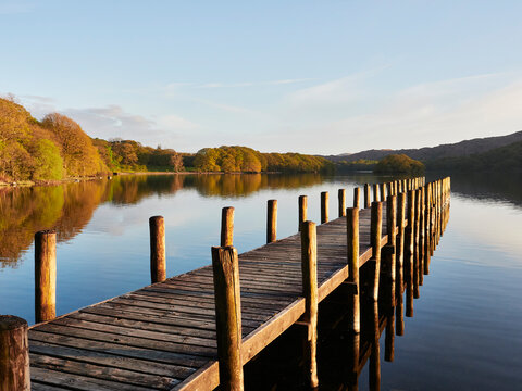 Sunset over jetty on Coniston water. Cumbria, UK.