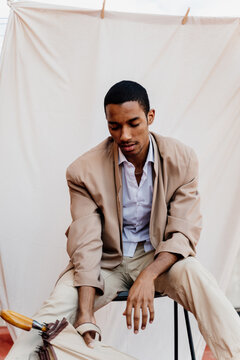 Portrait of stylish man in front of sheet background