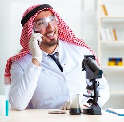 Arab chemist working in the lab office