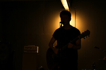 singer silhouette with guitar