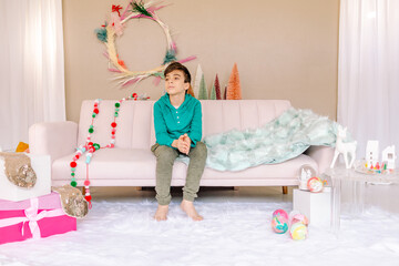 Teen boy on sofa in studio decorated for Christmas