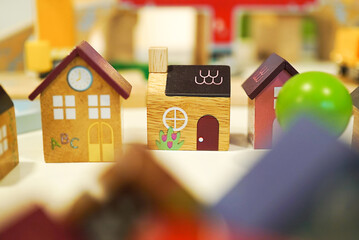 Wooden town made of small cute toy houses with soft focus