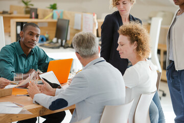 Office workers talking at desk