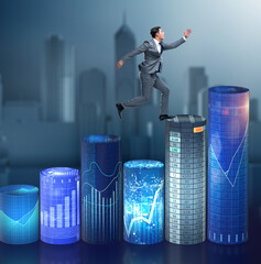 Businessman jumping over bar charts