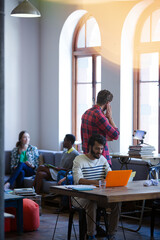 Creative business people working in sunny open office