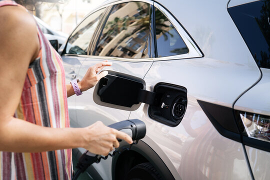Crop image of a woman charging Electric Car