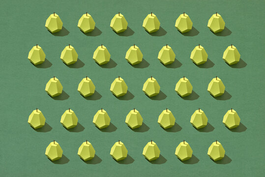 top view of textured pattern with handmade paper pears isolated on green