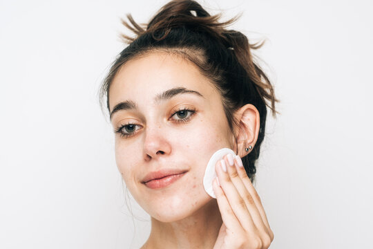 Woman With No Make Up Cleaning Her Face Studio Shot