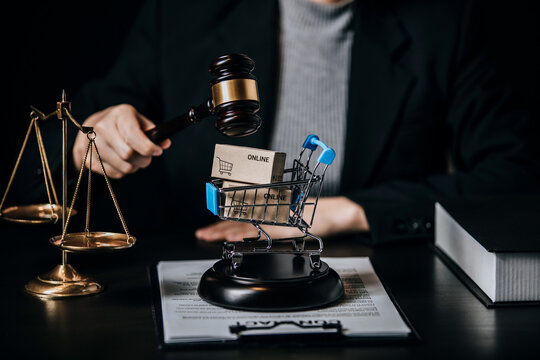 Law firm office, close up view of businesswoman or female lawyer consulting about contract paper with judges gavel, scales of justice, document legal, e-commerce law, justice advice service concept