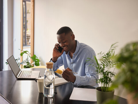 Jovial businessman talking on phone.