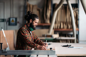 Carpenter Writing Down Ideas