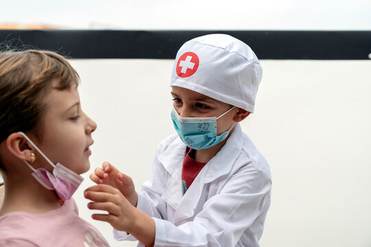 Little brother playing doctor with his sister