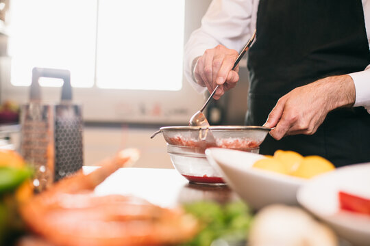 Crop chef making sauce 