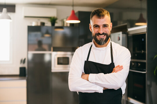 Confident chef standing in kitchen  - Powered by Adobe