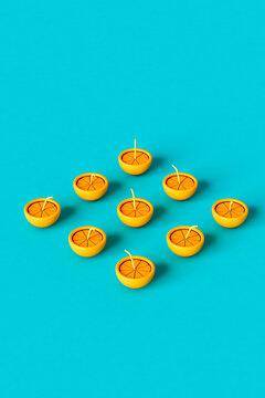 3D render of an orange with a straw on blue background