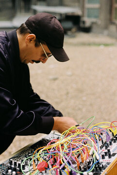 A musician playing an analog synthesizer. 