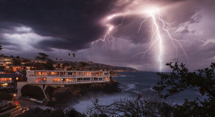 Lightning flashes over a cliff overlooking the ocean