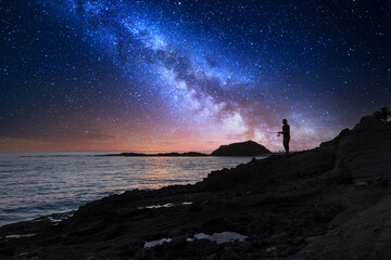 milky way over Silhouette of Fisherman holding a fishing pole