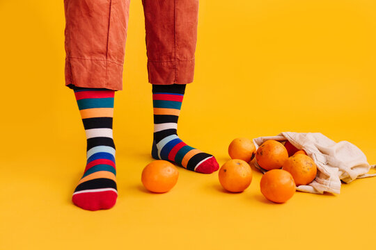 Close-up of feet and oranges