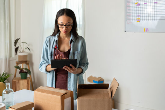 Woman Uses Tablet to Track Packages