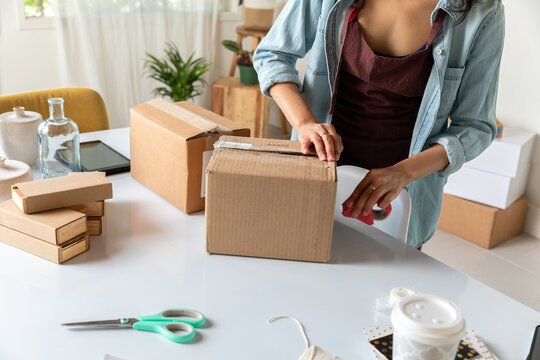 Woman Packages Cardboard Box