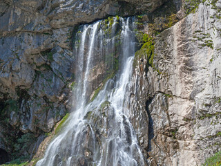 Fototapeta na wymiar Waterfall on gray stone rock texture background