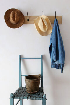 Fototapeta Straw hats and shirt  hanging on hooks