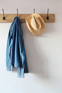 Jean shirt and hat hanging on hooks