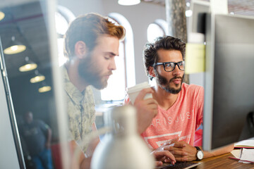 Creative business people working in sunny open office