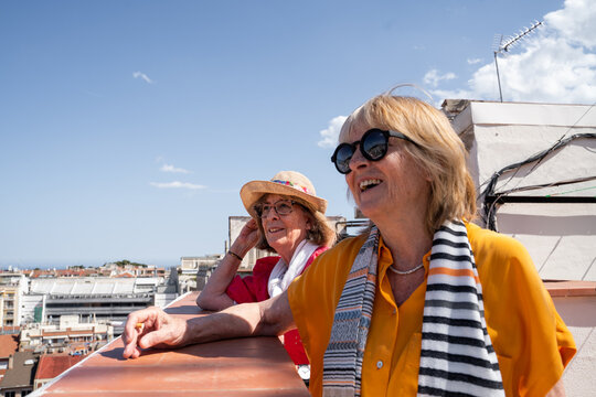Happy Senior friends  looking at views from rooftop