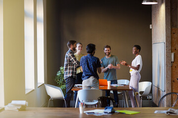 Casual business people working at tables in open office