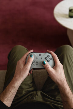 POV video game playing man with blue nails