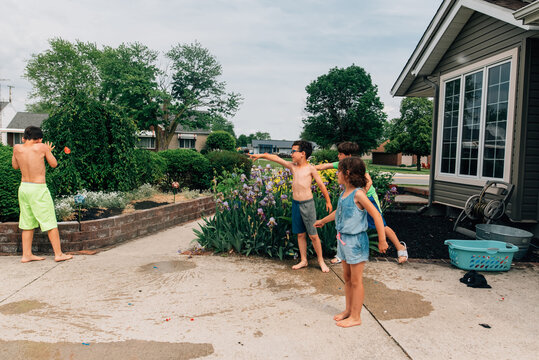 Boy Being Attacked By Water Balloons. 