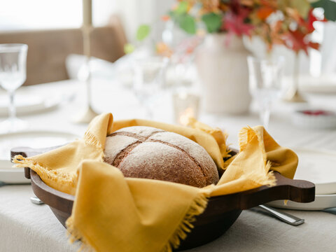 Fall decor table setting with foraged leaves and fresh bread